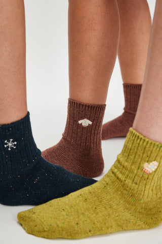 Four pairs of socks in different colors on a white background