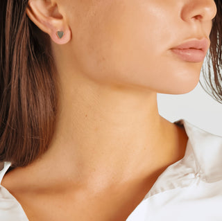 Close-up of a woman wearing heart-shaped earrings.