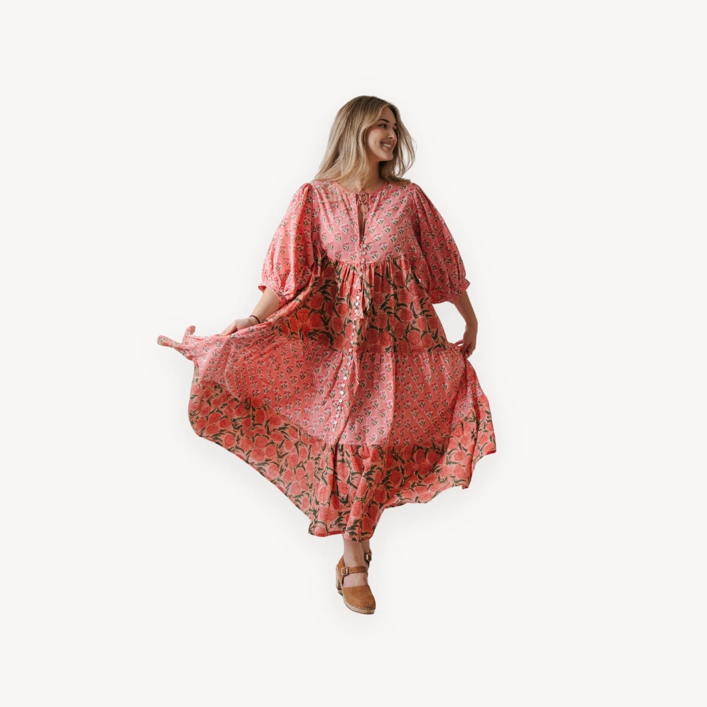 Woman wearing a red patterned dress on a white background
