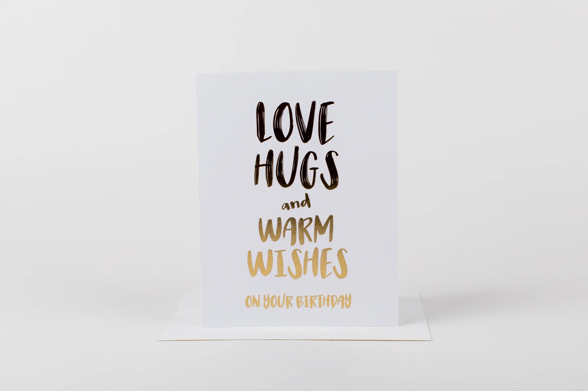 Card with 'Love hugs and warm wishes on your birthday' text on a white background