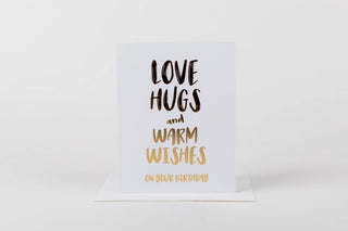 Card with 'Love hugs and warm wishes on your birthday' text on a white background