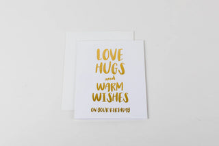 Greeting card with 'Love hugs and warm wishes on your birthday' text on a white background