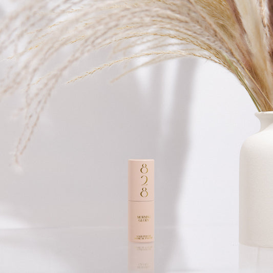 Skincare bottle labeled '828' on a white background with a decorative vase.