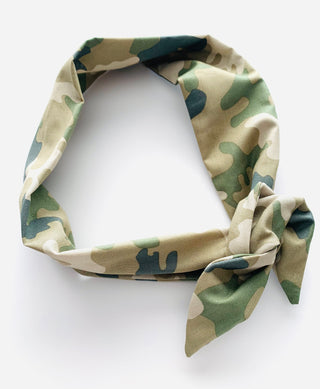 A lightweight fabric neck scarf with a classic green and beige camouflage pattern, styled in a loop with a tied knot at the bottom right, set against a plain white background.