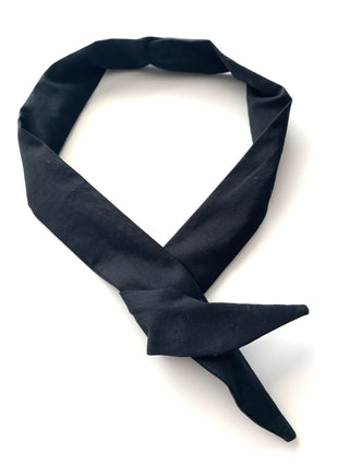 A black necktie tied in a knot and displayed on a clean white background.