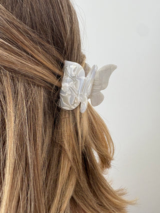 women wearing a butterfly hair clip