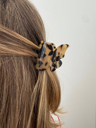 women wearing a tortoise colour butterfly shaped hair clip 