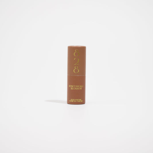 Brown tube with gold text on a white background