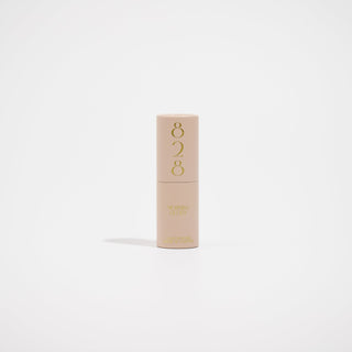 Beige perfume with '828' branding on a light beige background
