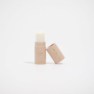 Two beige cosmetic tubes with a brand logo on a light beige background