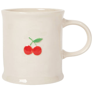 White mug with red cherries and green leaves on a white background