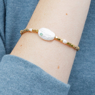 person wearing a beaded pearl bracelet