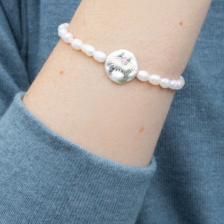 person wearing a pearl beaded bracelet