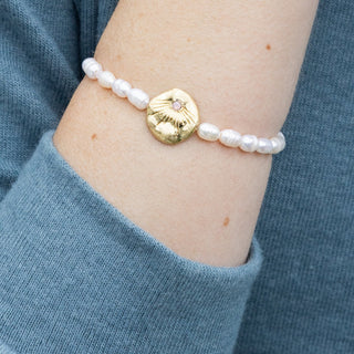 person wearing a pearl beaded bracelet