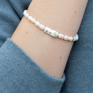 person wearing a pearl beaded bracelet