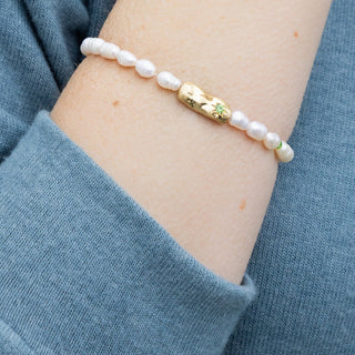 person wearing a pearl beaded bracelet