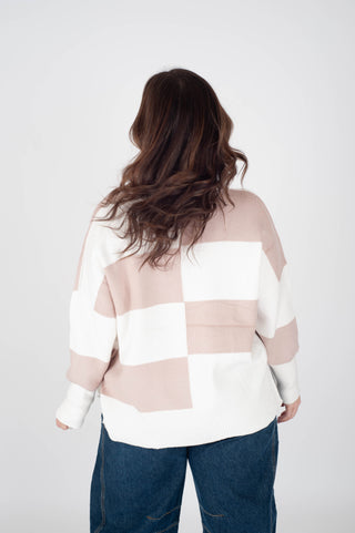 Person wearing a checkered sweater with a white background