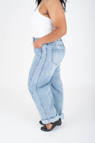Light blue jeans worn by a person on a white background
