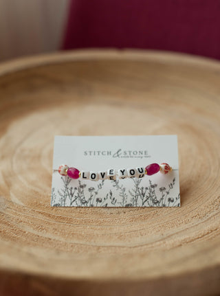 a beaded bracelet  that says i love you
