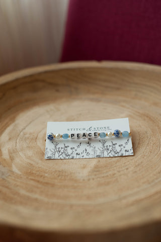 a beaded bracelet  that says peace