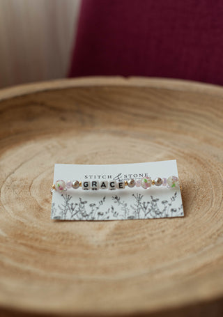 a beaded bracelet  that says grace