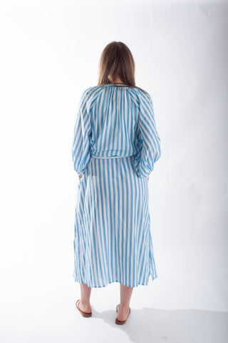 Woman wearing a blue and white striped dress on a white background