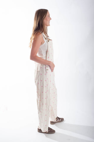 Woman wearing a white floral dress on a white background