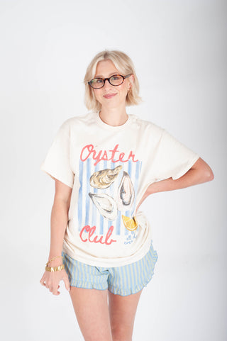 Person wearing a t-shirt with 'Oyster Club' design on a white background