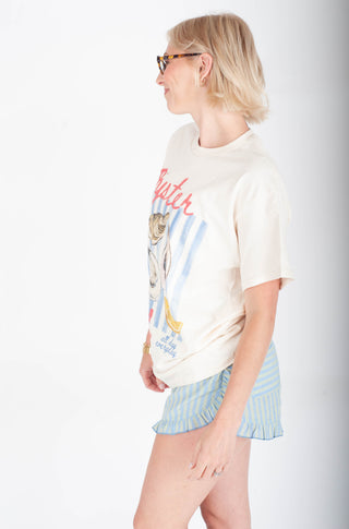 Person wearing a graphic t-shirt and shorts against a plain background