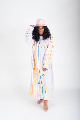 Woman wearing a colorful raincoat with geometric patterns on a white background