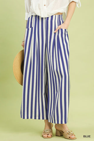 Person wearing blue and white striped pants on a green background