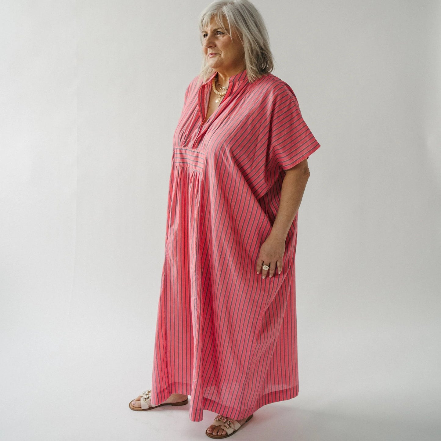 Woman wearing a pink dress against a white background