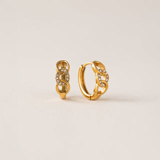 A pair of gold-colored hoop earrings with cubic zirconia set in a chain link pattern on a white background.