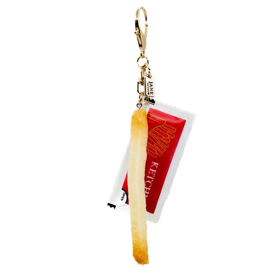 Keychain with a ketchup bottle and french fry design on a white background