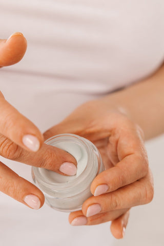a photo of a women applying cream based product