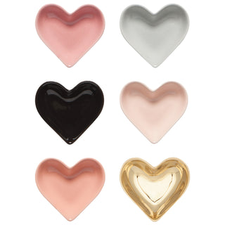 Set of heart-shaped dishes in various colors on a white background