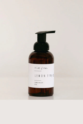 Brown bottle with pump and white label on a light gray background