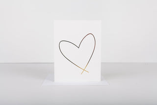 A white greeting card with a gold embossed heart design in the center, displayed on a white background.
