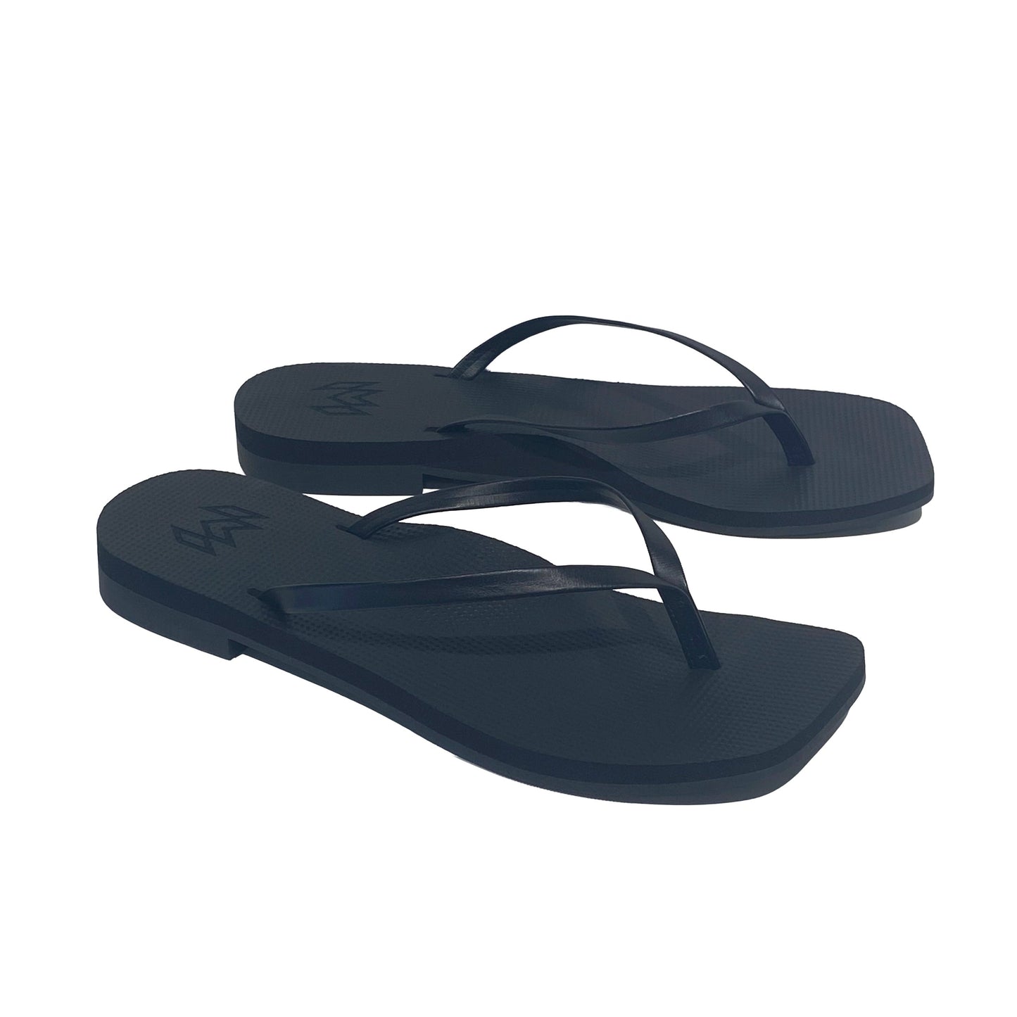 Pair of navy blue flip-flops on a white background