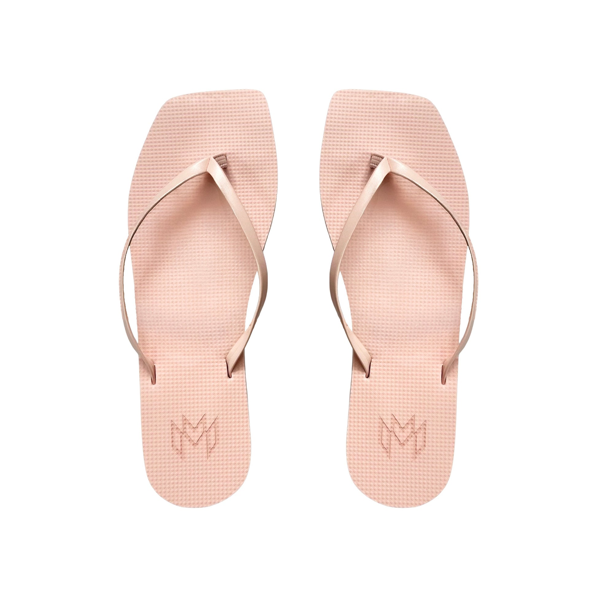 Pair of pink flip-flops with a brand logo on a white background