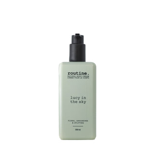Body cream bottle labeled 'routine. lucy in the sky' on a white background