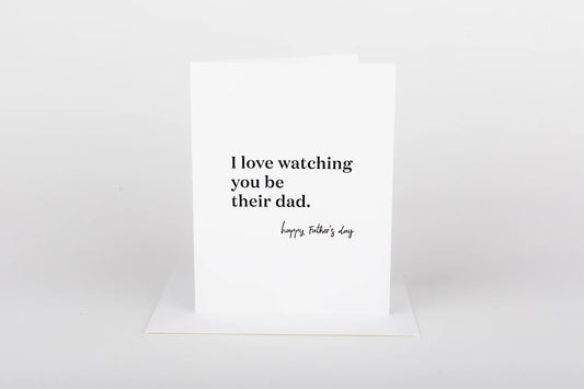 Greeting card with text 'I love watching you be their dad. Happy Father's Day' on a white background