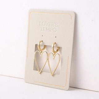 Heart-shaped gold earrings on a 'Lover's Tempo' branded card against a white background