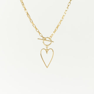 a gold chainlink necklace with a heart pendant 