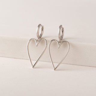 heart shaped earrings laying on a table