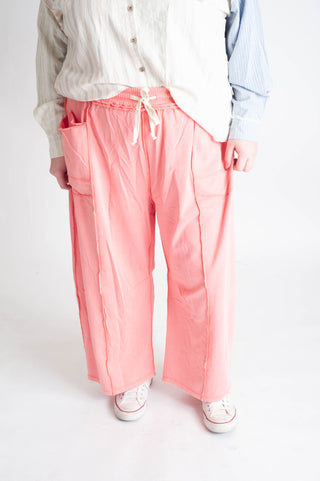 Person wearing pink pants with a white background