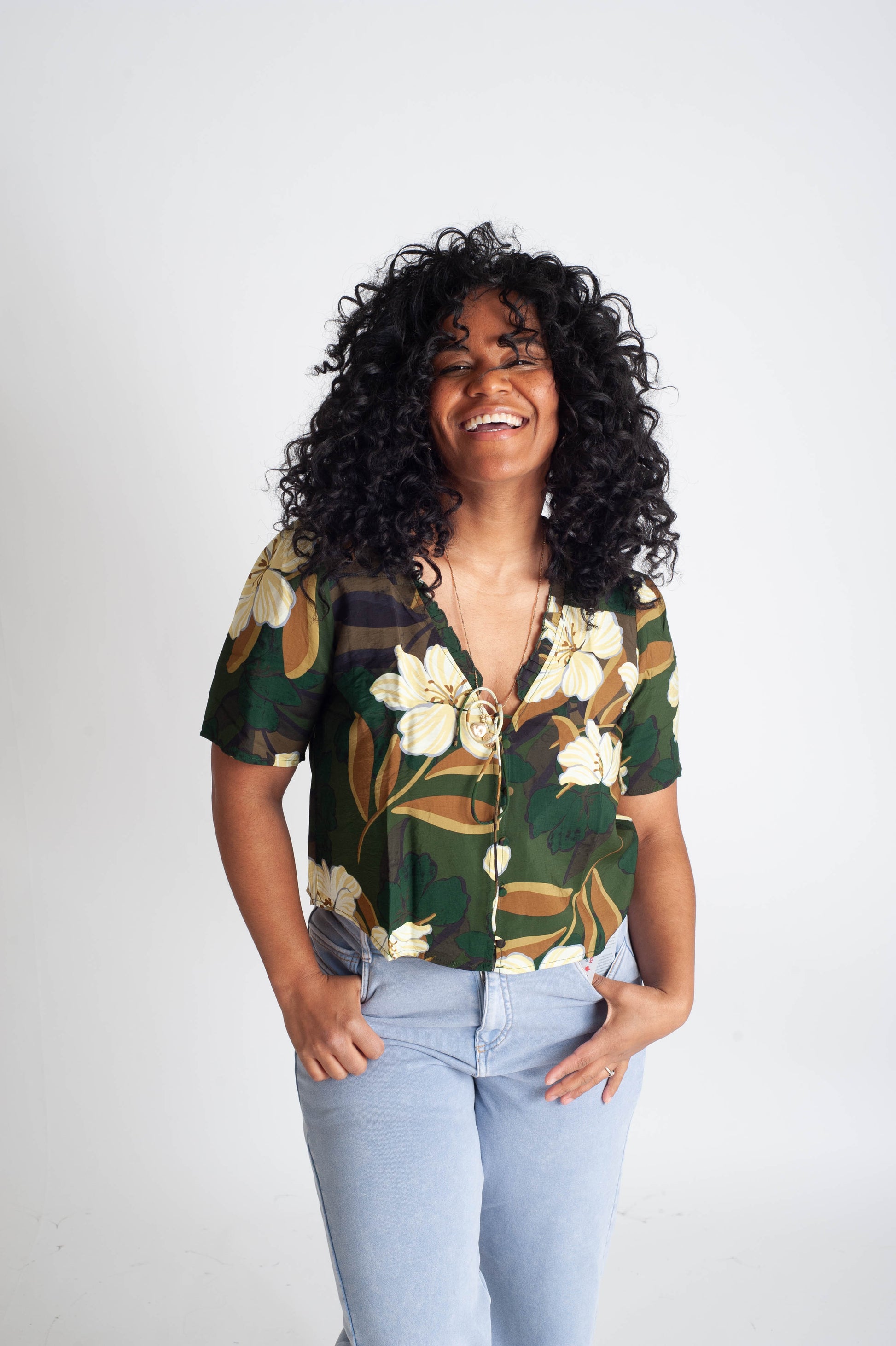 Woman wearing a floral blouse with a plain background