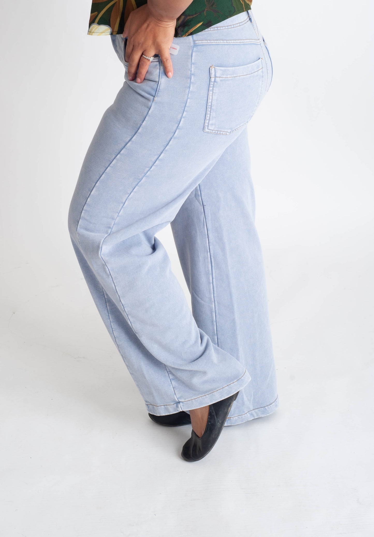 Light blue jeans worn by a person on a white background