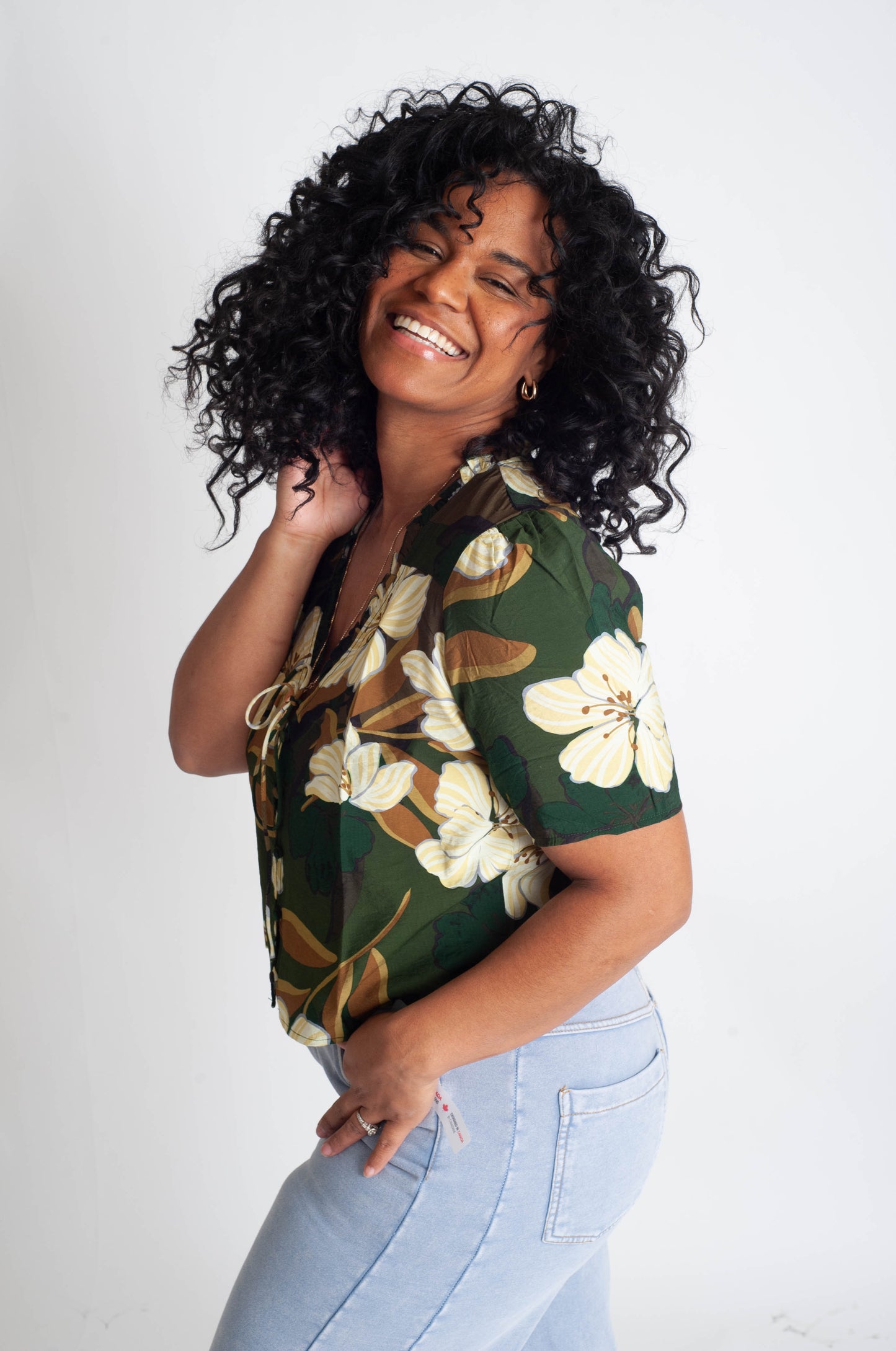 Woman wearing a floral shirt with a plain background