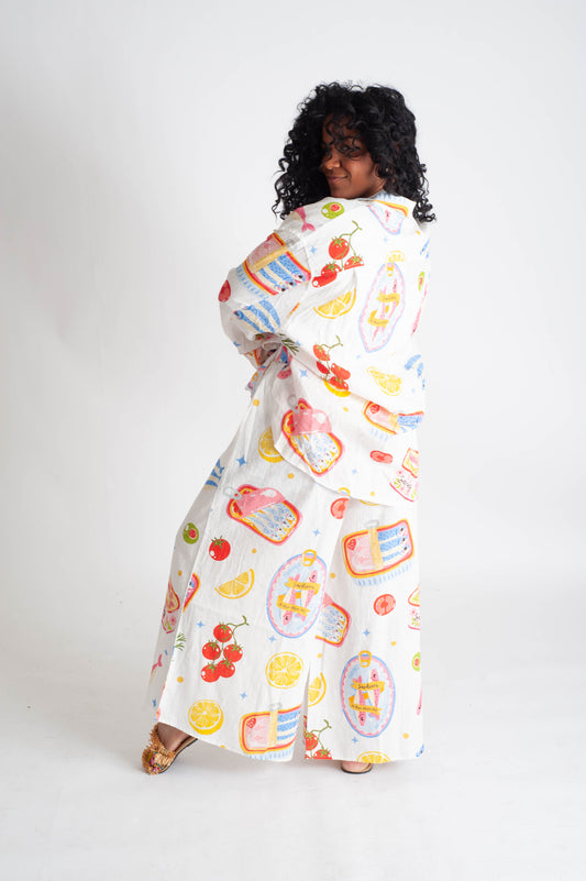 Woman wearing a colorful dress with a pattern on a white background